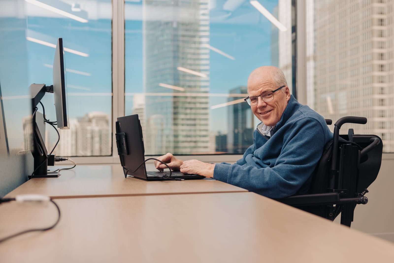 Mike working productively in an office, representing inclusive employment opportunities.